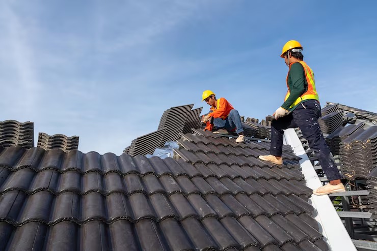 workers installing concrete roof tiles
