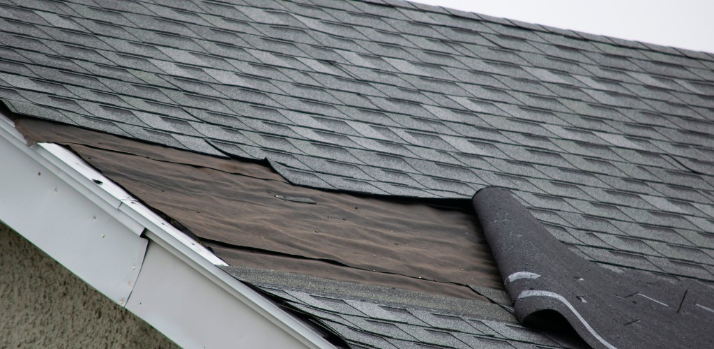missing asphalt shingles on a roof edge